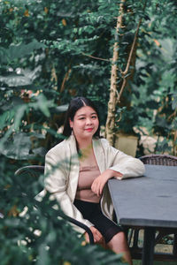 Portrait of smiling woman sitting outdoors