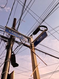 Low angle view of electricity pylon against sky