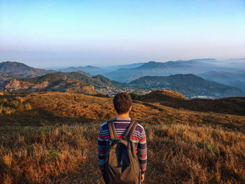 Rear view of man looking at mountains