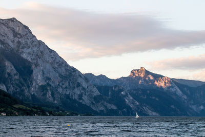 Scenic view of sea and mountains against sky