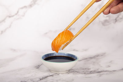 Salmon nigiri, chop sticks and soy sauce