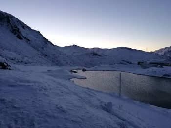 Scenic view of snow covered mountains against sky