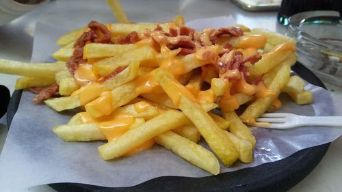 Close-up of fries with meat and vegetables on plate