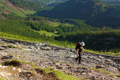 Full length rear view of man walking on mountain