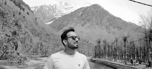 Portrait of young man standing on mountain