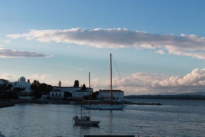 Sailboats sailing in sea against sky during sunset