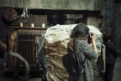 Rear view of woman photographing