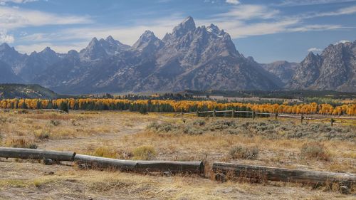 Scenic view of field and mountains against sky