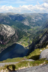 Scenic view of river and mountains against sky