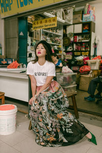 Portrait of woman standing at market stall