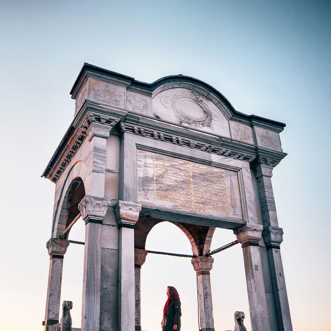 low angle view, architecture, built structure, clear sky, outdoors, real people, day, statue, building exterior, sky