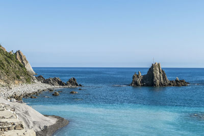 Small rock in the sea with a christian cross in riva trigoso