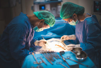 Surgeons performing surgery in operating room