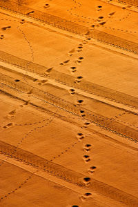 High angle view of tire tracks on desert