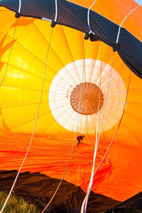 Low angle view of hot air balloon against orange sky