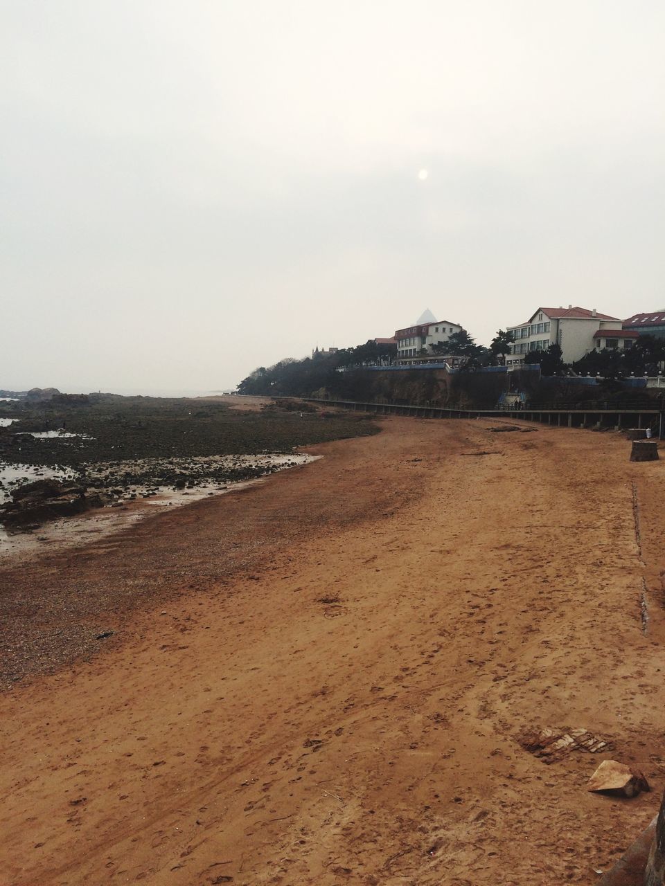 beach, sand, building exterior, sea, built structure, architecture, water, clear sky, shore, copy space, sky, coastline, tranquility, tranquil scene, scenics, incidental people, nature, day, beauty in nature, outdoors