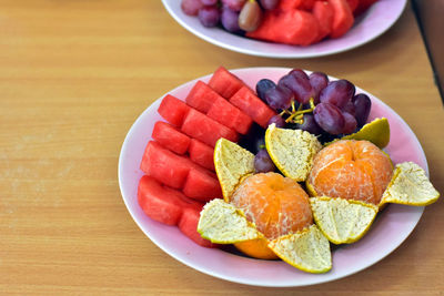 High angle view of fruits in plate on table