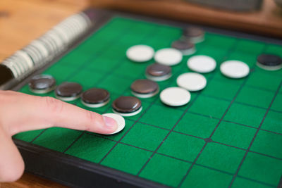 Cropped hand playing board game