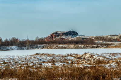 Scenic view of field against sky during winter