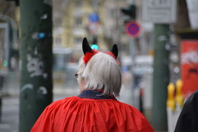 Rear view of person wearing costume standing in city