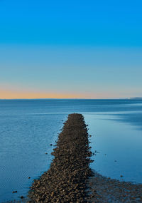 Scenic view of sea against clear blue sky