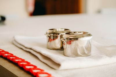 Close-up of shiny containers on table at home