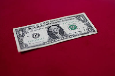 Close-up of paper currency on red background