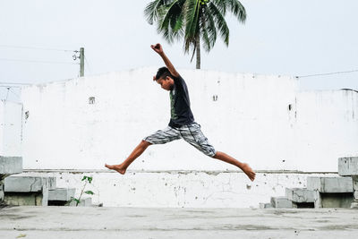 Full length of young woman jumping