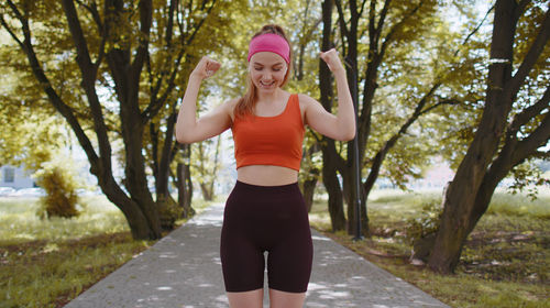 Portrait of young woman exercising in park