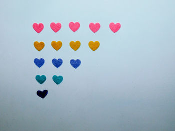 Close-up of multi colored heart shape over white background