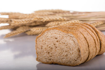 Close-up of bread on table against white background