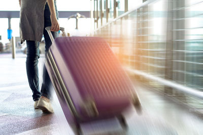 Low section of man walking at airport