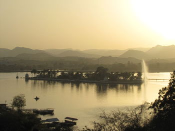 Scenic view of lake against clear sky during sunset