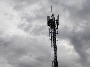 Low angle view of communications tower against sky