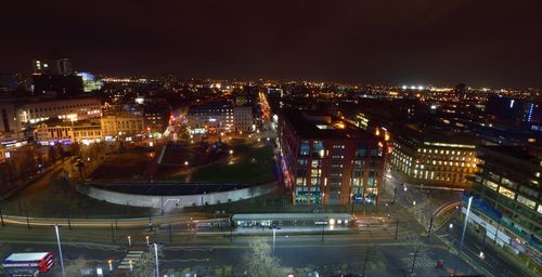 Illuminated cityscape against sky at night