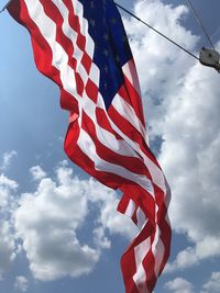 Low angle view of american flag against sky