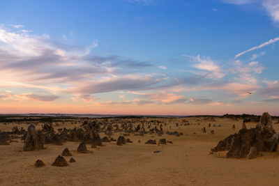 Panoramic view of desert against sky during sunset