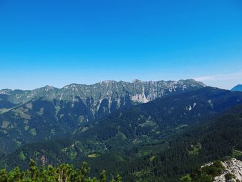 Scenic view of mountains against clear blue sky