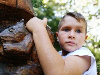 Close-up portrait of boy holding crab