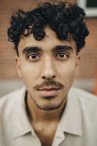 Portrait of young man with curly hair