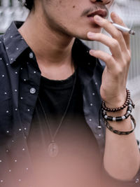 Midsection of woman holding smart phone