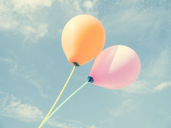 Low angle view of balloons against sky