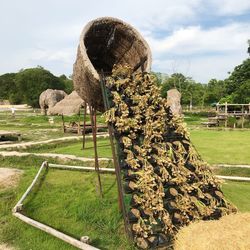 Hay bales on field against sky