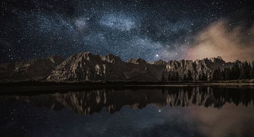 Scenic view of lake against star field at night