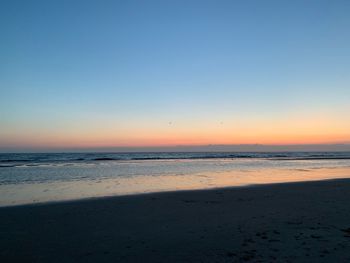 Scenic view of sea against clear sky during sunset