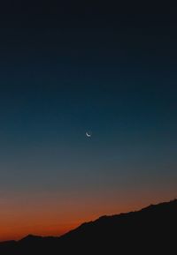 Scenic view of silhouette mountains against sky at night