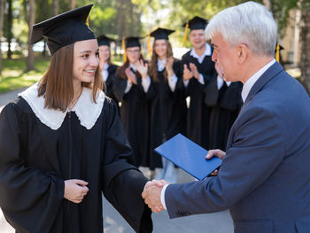 Portrait of man wearing graduation gown