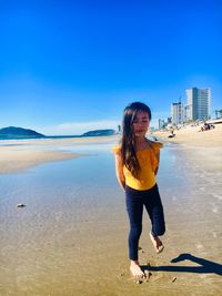 Full length of girl standing on beach