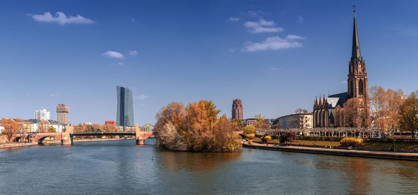 Bridge over river amidst buildings in city