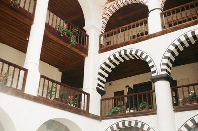 Low angle view of building seen through balcony